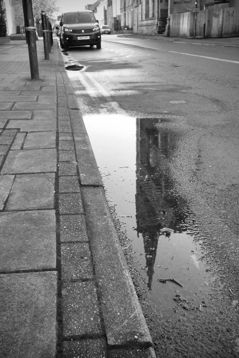 Reflections in the street of All Saints Church