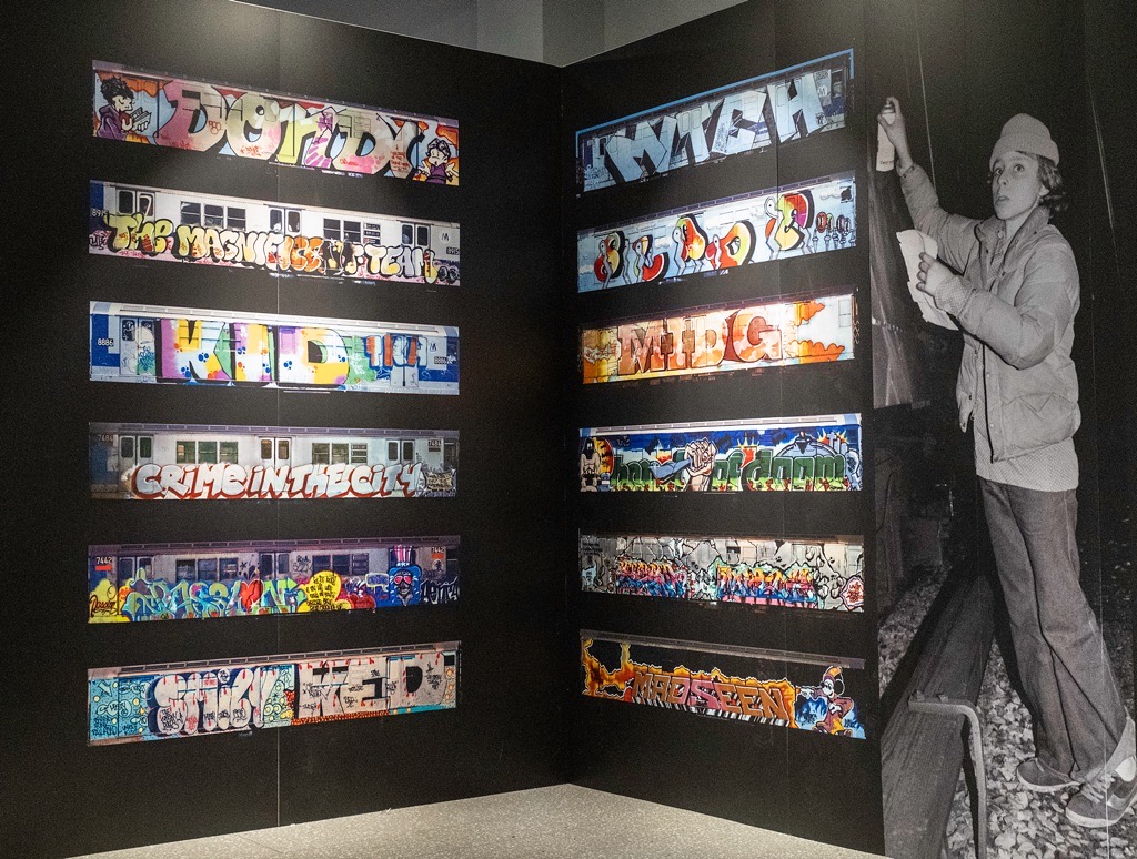 The picture shows several boards with the subway trains meticulously photographed in their number order.