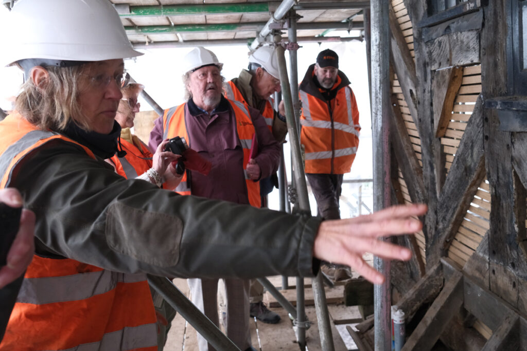 Hard Hat Tour Group
Visitors wearing hard hats and high-visibility jackets during a guided Golden Lion restoration tour. 