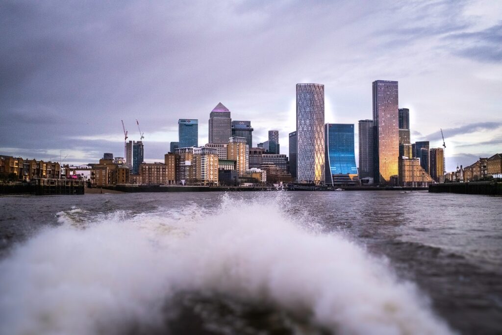 Evening river bus journey with London skyline views.