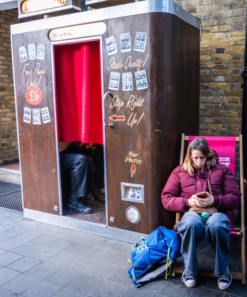 MrWhisper leading a street photography walk at Greenwich Street Market. At a Photo Booth.