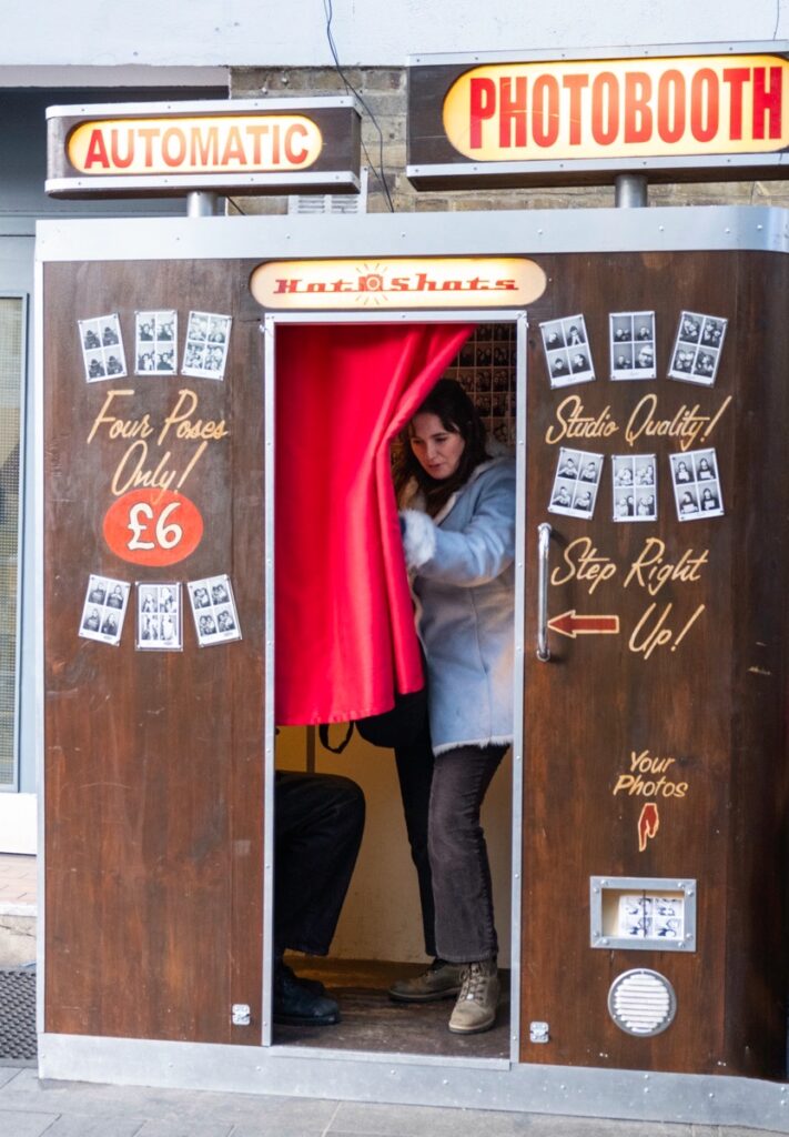 MrWhisper leading a street photography walk at Greenwich Street Market. At a Photo Booth.