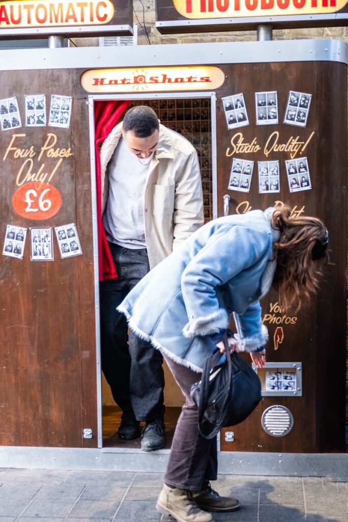 MrWhisper leading a street photography walk at Greenwich Street Market. At a Photo Booth.