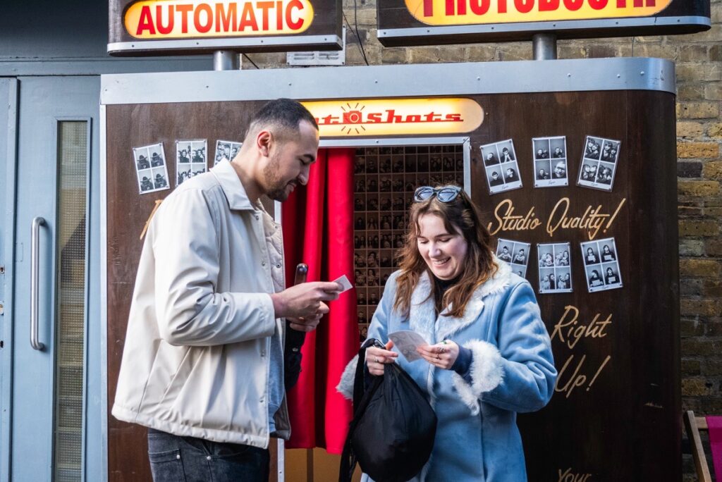 MrWhisper leading a street photography walk at Greenwich Street Market. At a Photo Booth.