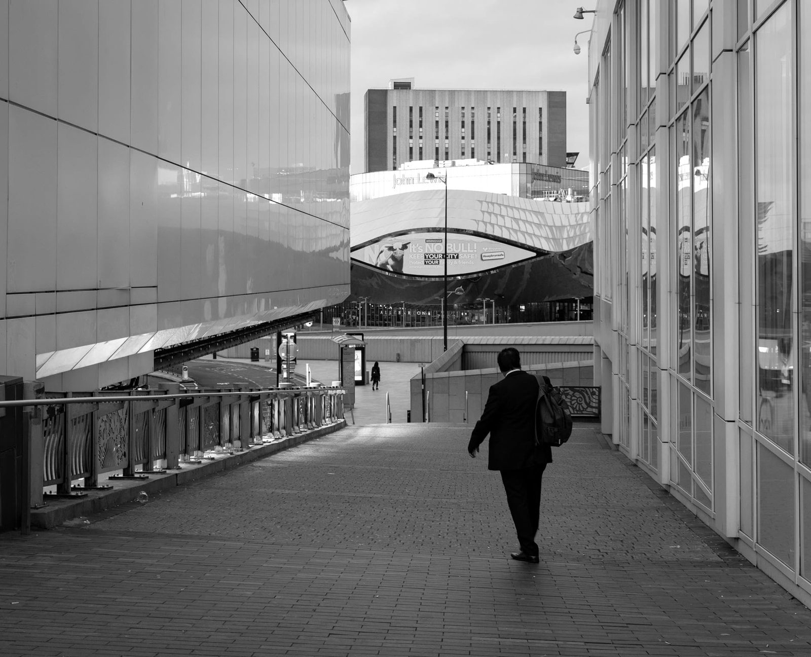 Single Figures move through the empty passageways
