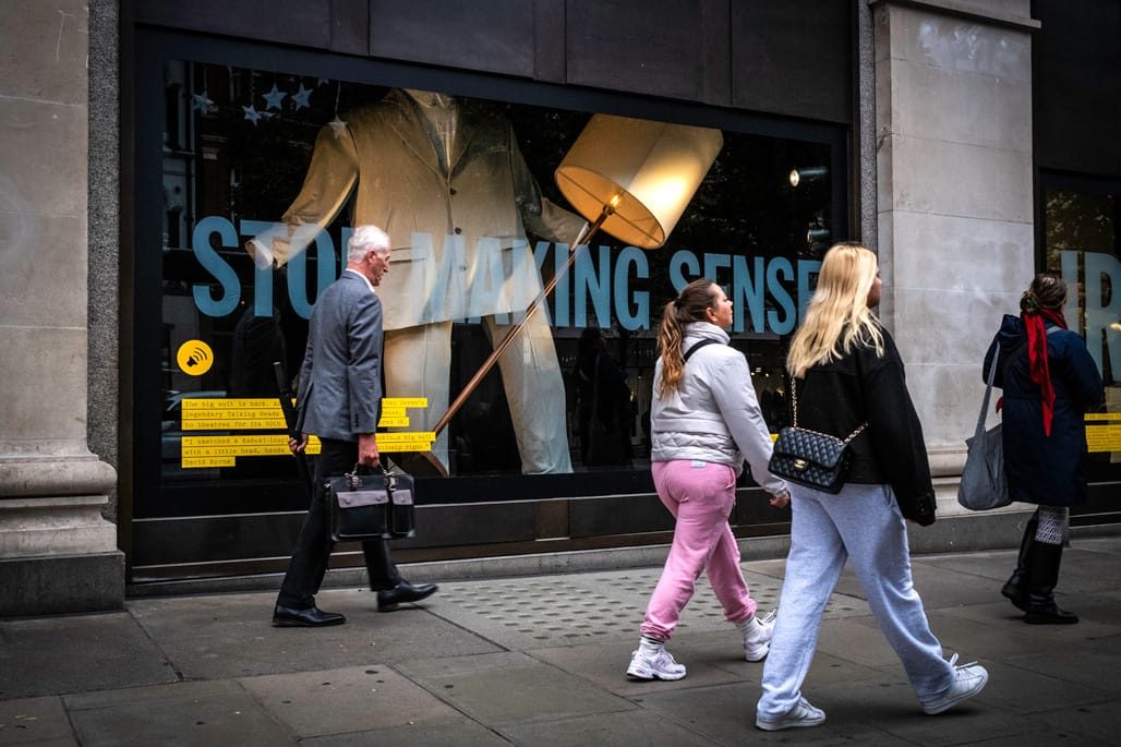 People watching outside Selfridges windows on Oxford Street.