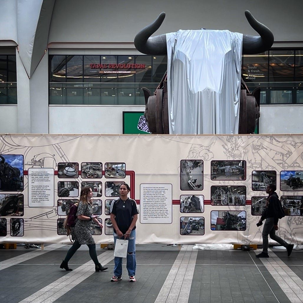 Ozzy the Bull arrives in New Street station, Birmingham. 2023